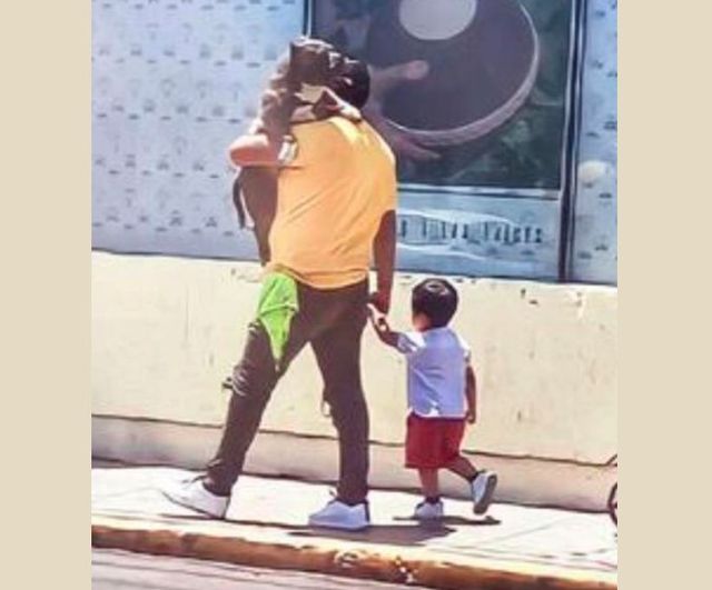 Father Praised For Choosing To Carry His Large Dog Instead His Small Son
