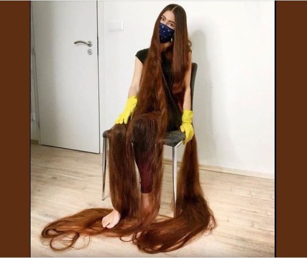 Real life Rapunzel has hair brushing the ground behind her with 90-inches of flowing brown locks.