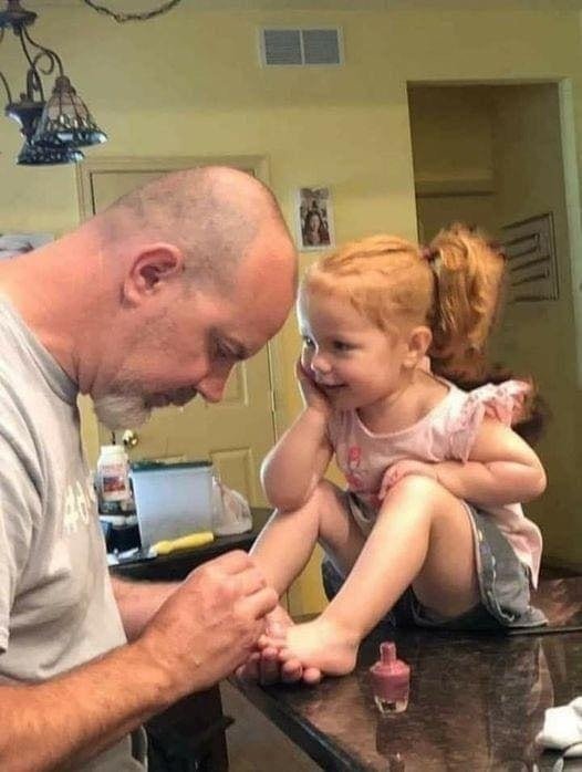 Firefighters calm down scared little girl at crash scene by asking her to paint their nails